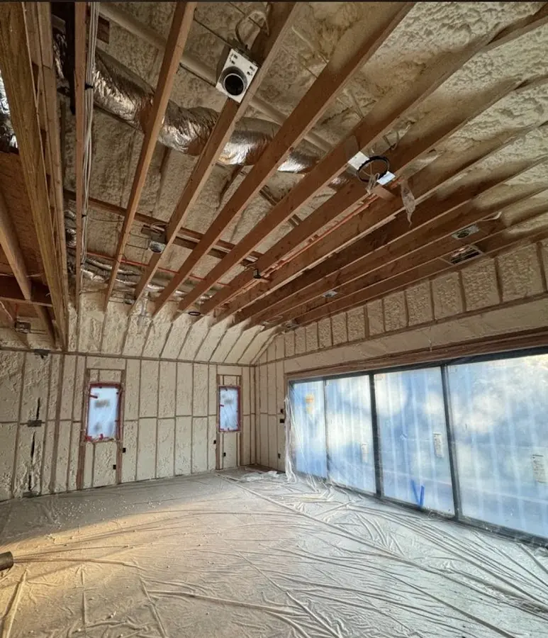 Interior walls and ceiling insulated with spray foam during new construction in Newport